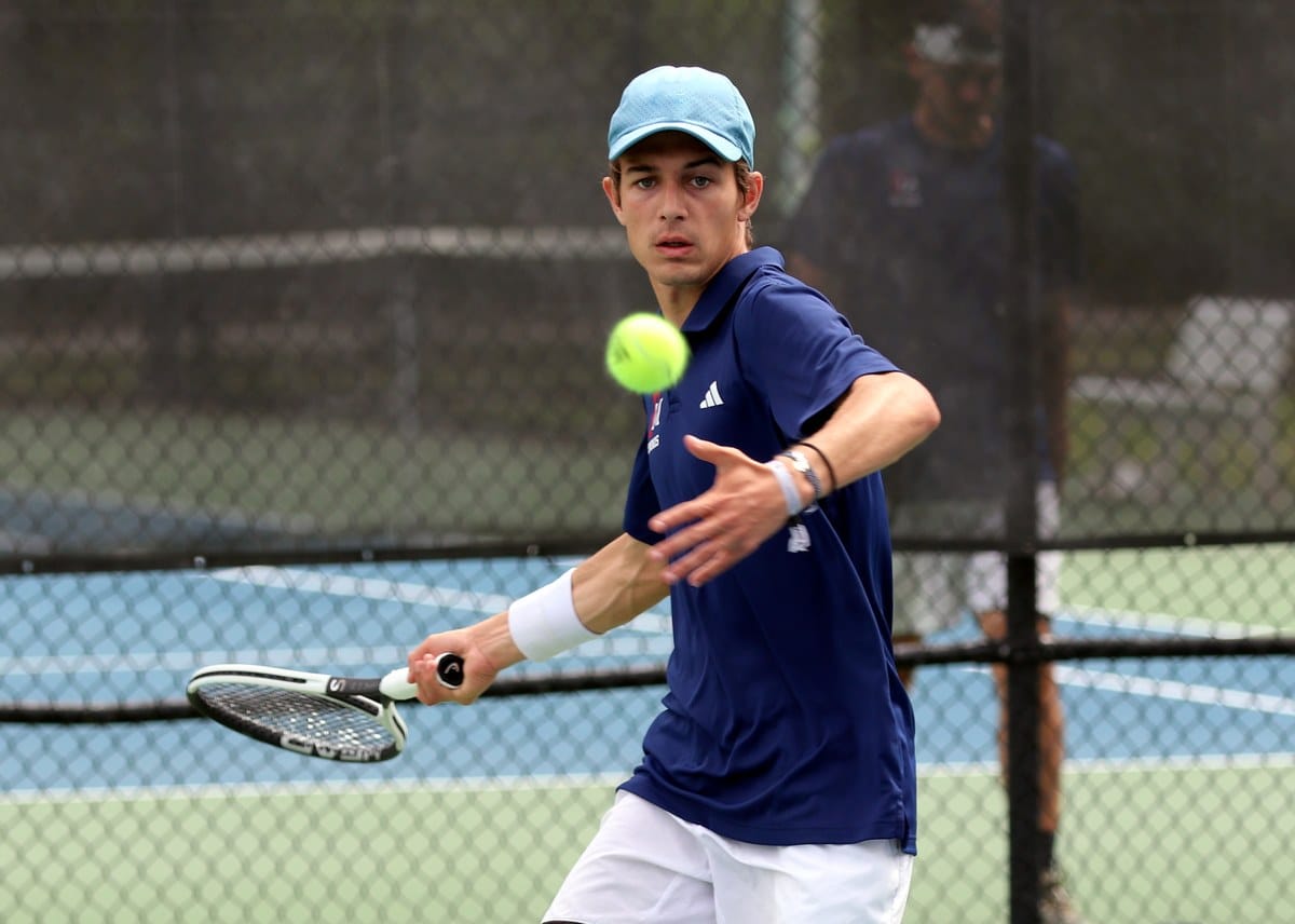 Miguel Maia hits a forehand for Francis Marion University against Barton