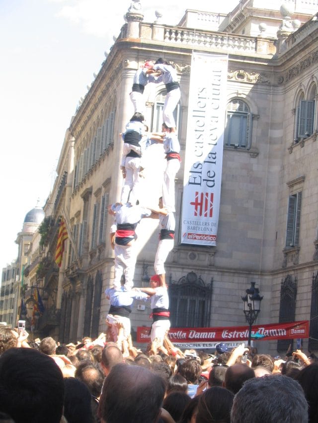 Castellers build a human tower in Plaça de Sant Jaume during La Mercè.