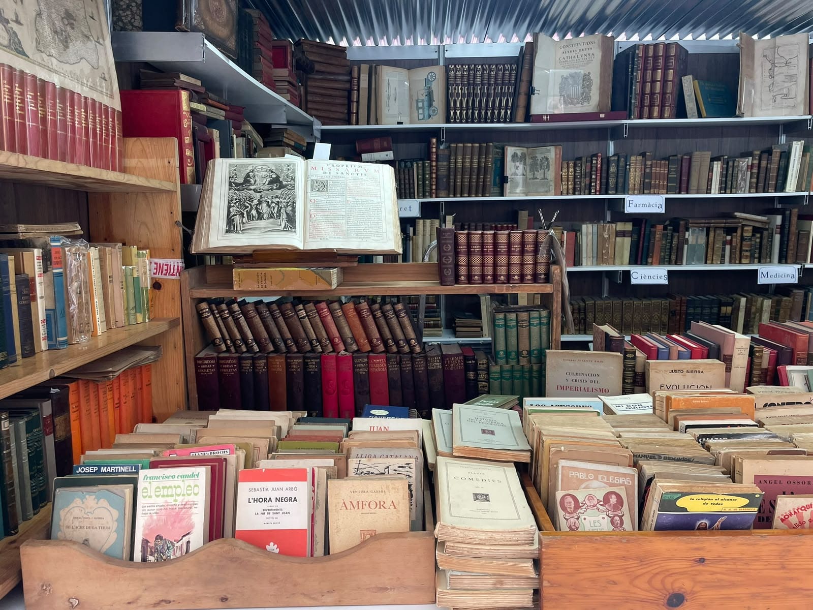 Books laid out on a second-hand bookstall under a white tent.
