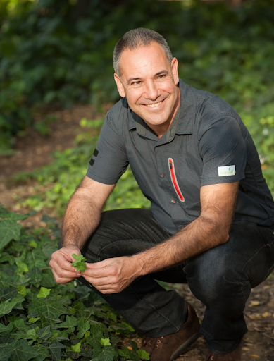 Biologist and gastro-botanist Evarist March, crouched in woodland with a leaf in hand