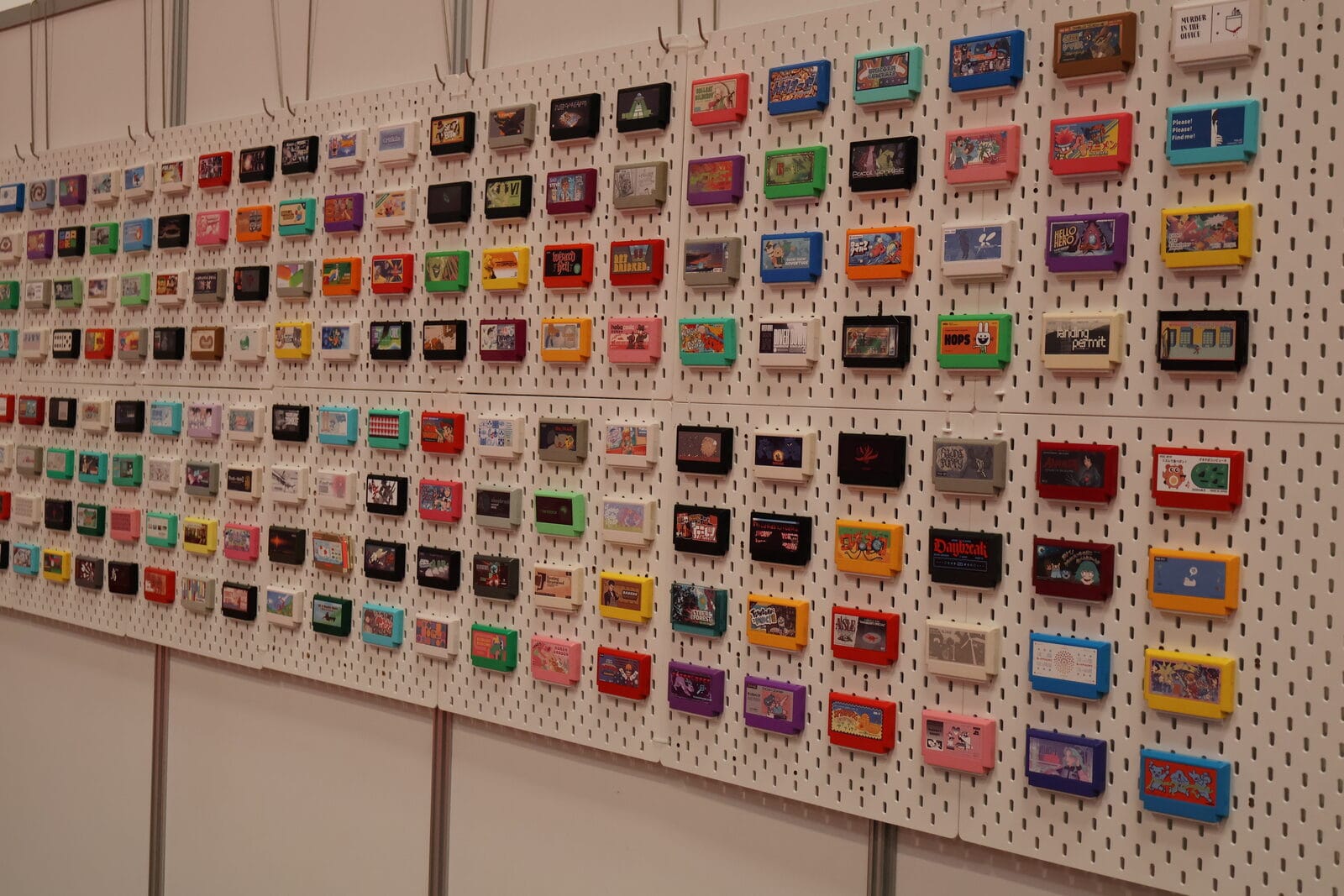 A wall of Famicom-style cartridges in assorted colours