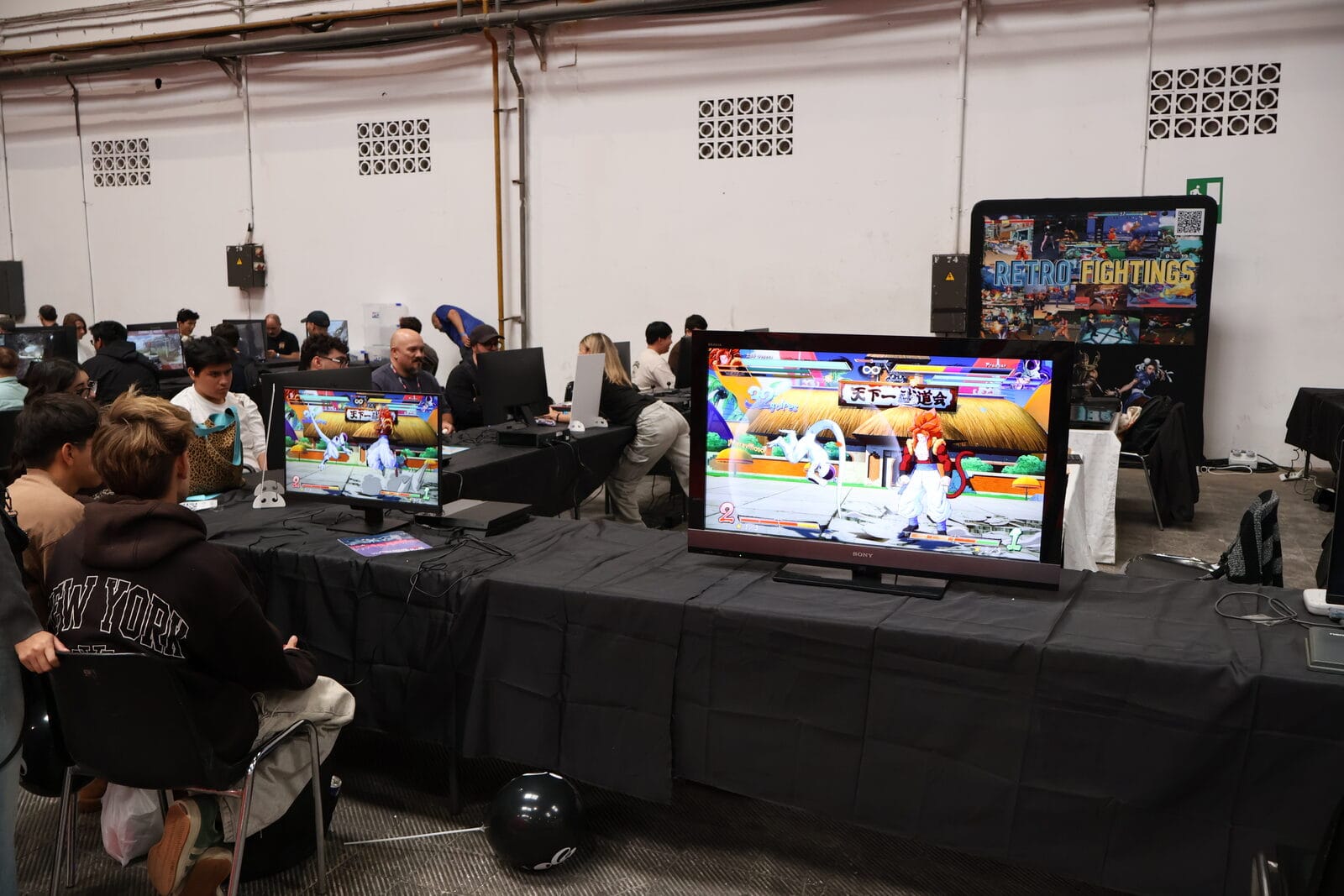 Competitors and onlookers crowded round the fighting game displays