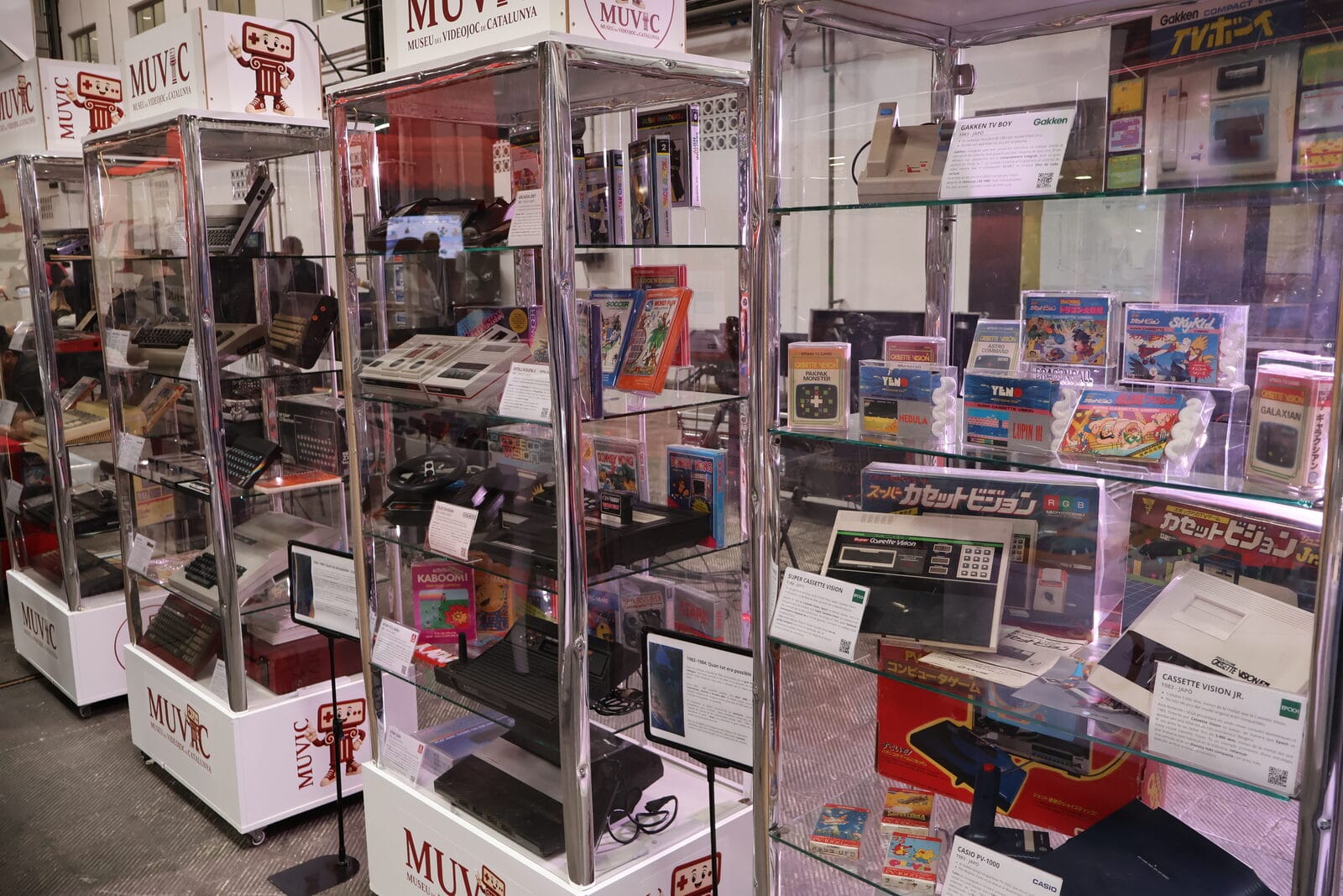 Vintage consoles in glass display cases at the MUVIC stand