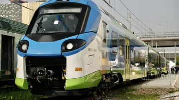 Graffiti covers the side of a new train carriage at a railway facility in Mataró.