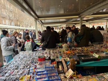 Collectors gather outside Mercat de Sant Antoni in Barcelona as police monitor World Cup sticker trading.