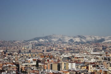 Snow-dusted rooftops and the Collserola hills after a rare snowfall in Barcelona