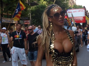 Participants and decorated double-decker floats at a Pride Barcelona march on Gran Via in central Barcelona.