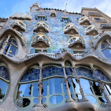 A close-up view of artisanal chocolate replicas of Gaudí's architectural details, arranged in a branded box, photographed in Barcelona.