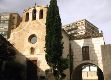 Exterior of the Santa Eulàlia de Vilapicina sanctuary in Barcelona's Nou Barris district, a neoclassical church with stone façade and arched windows.