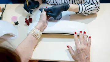 A row of beauty and nail salons on a Barcelona street, with signs in Catalan and Spanish advertising manicures and aesthetic services.