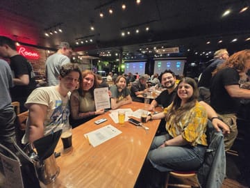 Solvers working through a puzzle packet at a Puzzled Pint event