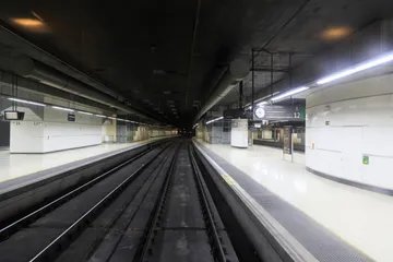 A view of the railway tunnels leading into Barcelona Sants station, showing overhead electrical systems and tracks.