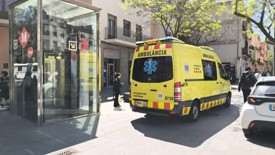A Barcelona TMB metro train stopped at a platform on the L1 line.