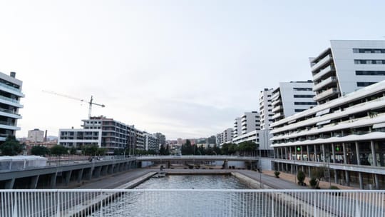 A modern residential building with many balconies, representing public housing in a city environment.