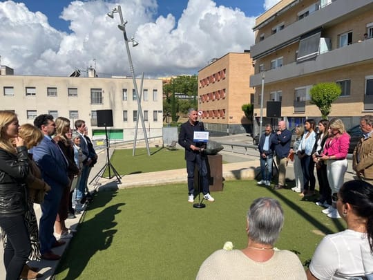 People gathered at Plaça dels Treballadors de la Haissa in Badalona, observing a minute of silence during a commemoration cer