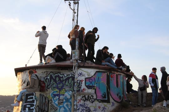 Panoramic view of Barcelona from the Carmel Bunkers at Turó de la Rovira, showing the city skyline and the Mediterranean Sea.