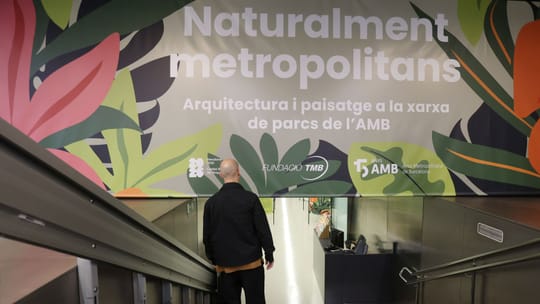 Exhibition panels showing the transformation of metropolitan areas from industrial to green spaces, with people viewing the d