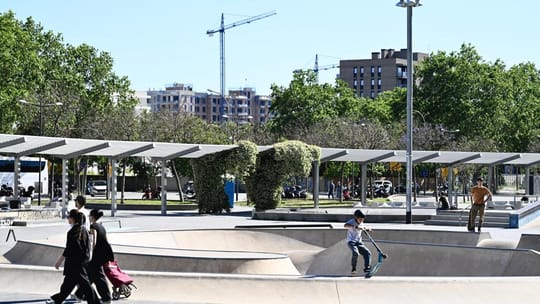 Construction cranes and new buildings in Barcelona's La Marina del Prat Vermell district with Montjuïc mountain in the backgr