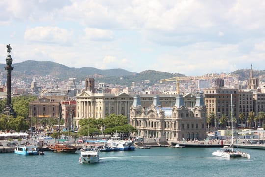 Aerial view of Barcelona's Ciutat Vella district, showing the dense urban fabric of Raval, La Rambla, and the port area leadi