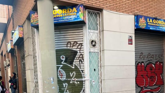 Police tape and officers investigating a crime scene on a street in Barcelona's Sants-Montjuïc district.