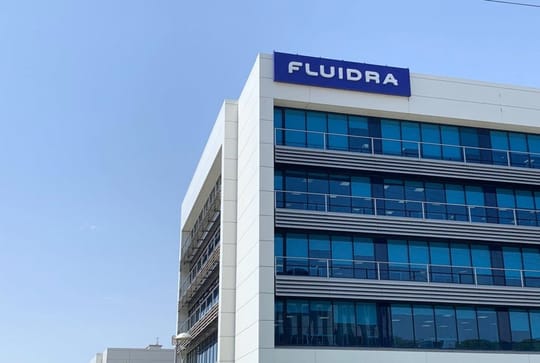 Fluidra logo displayed on a building facade, representing the company's global presence in the pool and wellness sector.