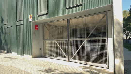 Underground parking garage with empty spaces and concrete pillars.