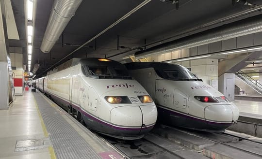 High-speed train on tracks with blurred background of countryside.
