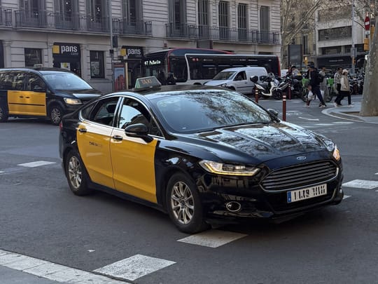 Taxis wait outside the passenger terminal at Barcelona Airport, where travellers arrange onward transport.