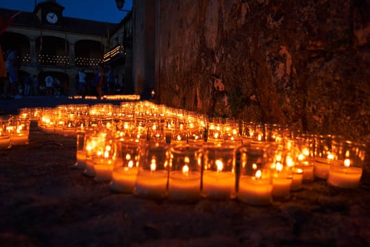 Night view of the Gothic cloister at Monestir de Pedralbes in Barcelona during a summer light and sound event.