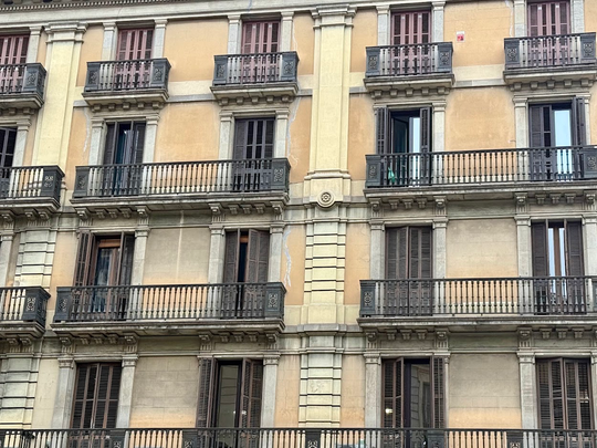 Residential apartment buildings in Catalonia, illustrating the dispute over proposed restrictions on speculative home purchases.