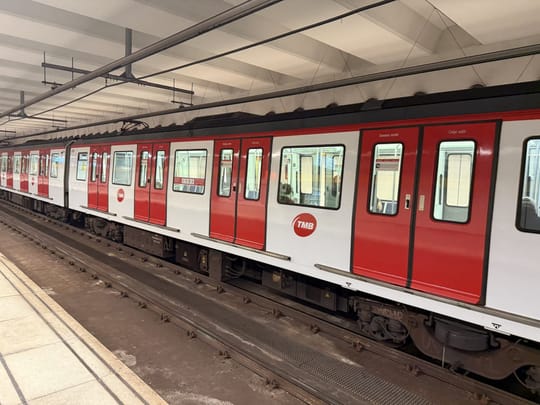 A Barcelona Metro train stands at a station platform, illustrating the rail network covered by Mossos d'Esquadra crime figures.