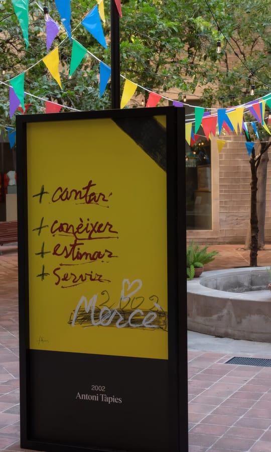 Exhibition of 48 official La Mercè festival posters displayed in the courtyard of the Frederic Marès Museum in Barcelona.