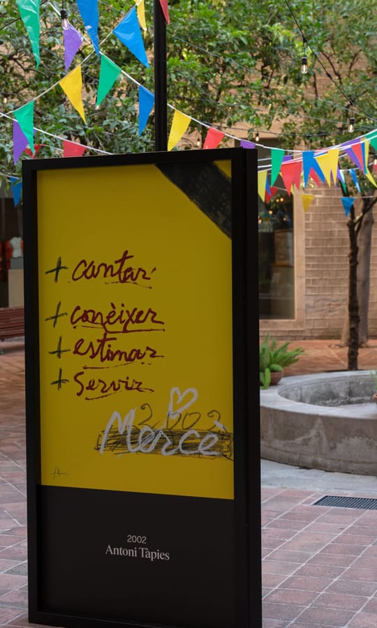 Exhibition of 48 official La Mercè festival posters displayed in the courtyard of the Frederic Marès Museum in Barcelona.