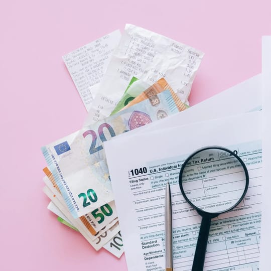 Tax and accounting paperwork with a calculator on a desk