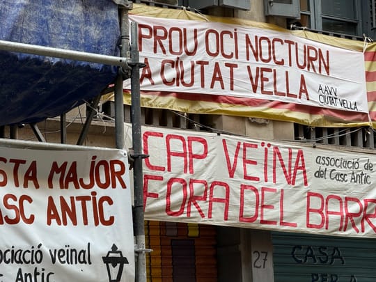 People walking along Barceloneta beach, where informal masseuses have been subject to coexistence ordinance enforcement.