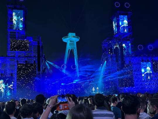 Palau Sant Jordi in Barcelona illuminated at night, hosting major concerts and events.