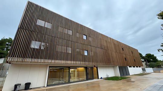 Exterior view of the new CAP Muntanyeta health centre in Castelldefels, a modern single-storey building with glass façades and signage, surrounded by green space.