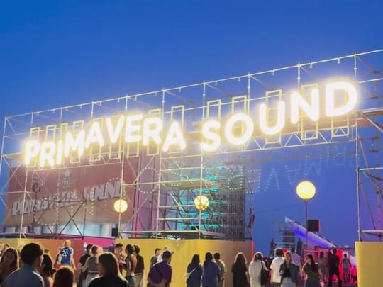 The illuminated Primavera Sound sign above festival-goers at Parc del Fòrum