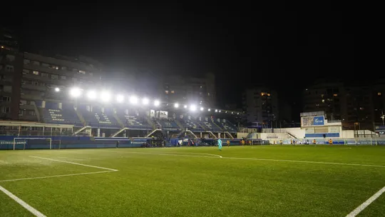 Nou Sardenya stadium in Barcelona's Gràcia district, home to CE Europa football club, with stands and an artificial pitch.