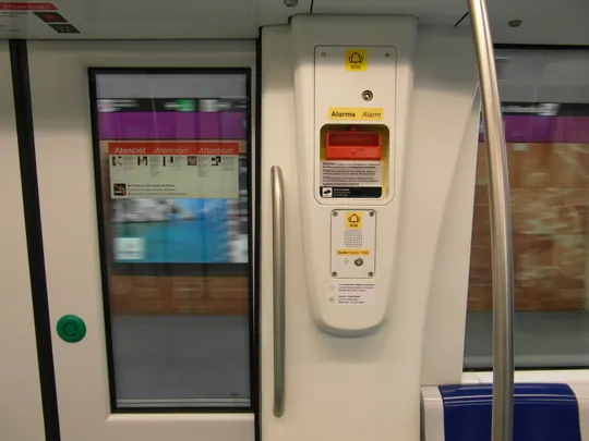 An underground metro tunnel in Barcelona showing structural damage and water marks on the concrete platform near Artigues | Sant Adrià station on the L2 line.
