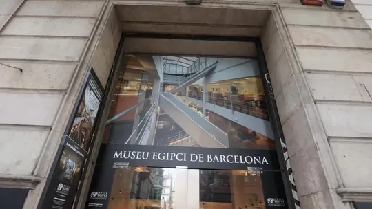 Exterior view of the Museu Egipci de Barcelona with signage for the new 'Iny, the Pharaoh's Explorer' exhibition.