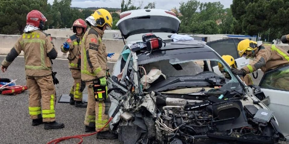 Emergency services vehicles, including fire engines and ambulances, attending a car and coach collision on a motorway hard sh