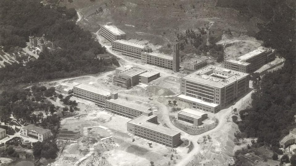 A modern university campus building with green spaces, contrasting with historical markers or a faded old photograph of a det