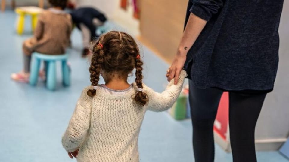 Children playing in a bright, modern childcare facility in Barcelona