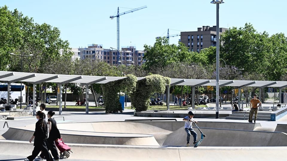Construction cranes and new buildings in Barcelona's La Marina del Prat Vermell district with Montjuïc mountain in the backgr