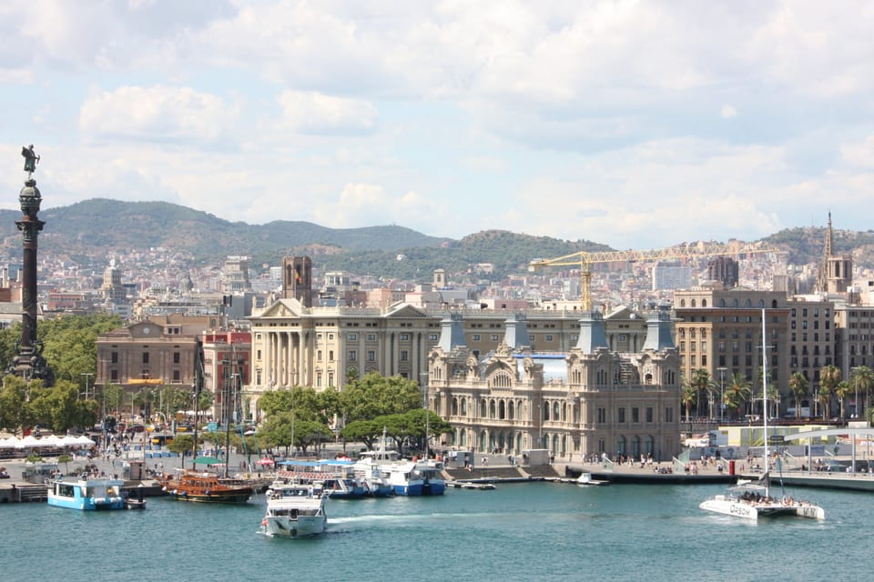 Aerial view of Barcelona's Ciutat Vella district, showing the dense urban fabric of Raval, La Rambla, and the port area leadi