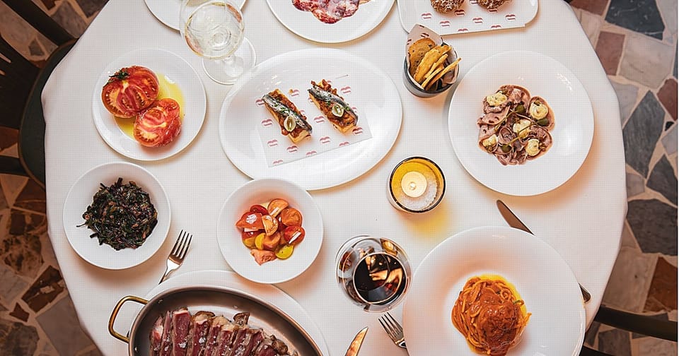 Elegant interior of Bottega Bernacca restaurant in Barcelona with dining tables and soft lighting.