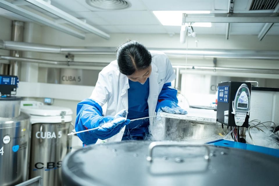 Researchers in a modern laboratory setting examining samples and using scientific equipment.
