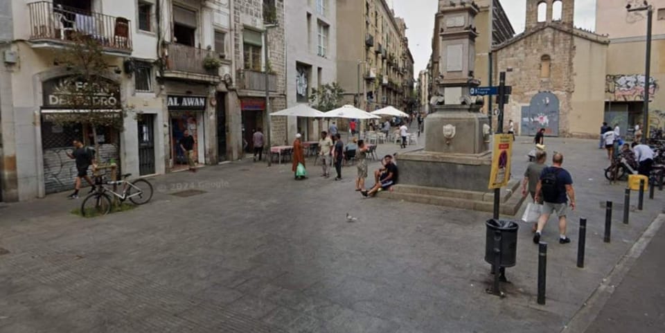 Police tape or a street scene in Barcelona's Raval district, possibly near Plaça del Pedró, indicating an investigation.