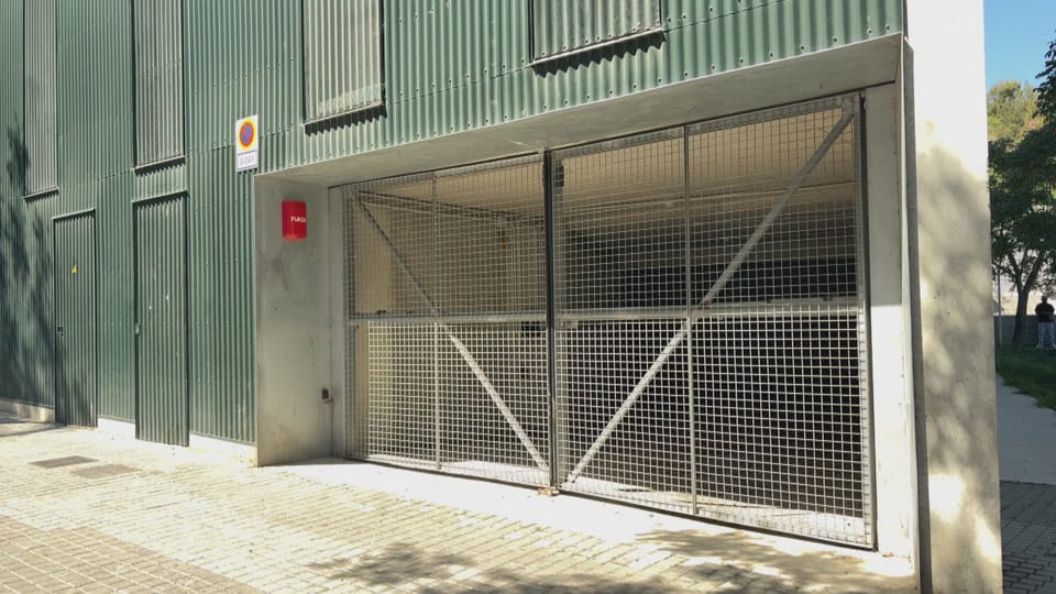 Underground parking garage with empty spaces and concrete pillars.
